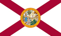 Florida state flag with the words "GREAT SEAL OF THE STATE OF FLORIDA - IN GOD WE TRUST"  in all caps.