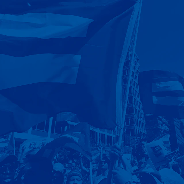 Square image of people carrying HRC flag with blue color treatment.