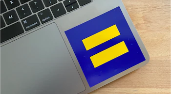 An HRC logo sticker on the corner of a laptop.