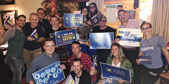 Group of people holding equality voter signs