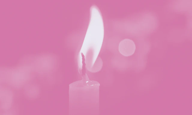 Lit candle with a pink color treatment