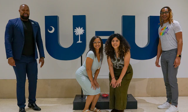 Group of people standing in front of a U=U sign