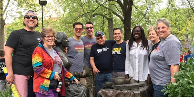 Group of people smiling in a garden