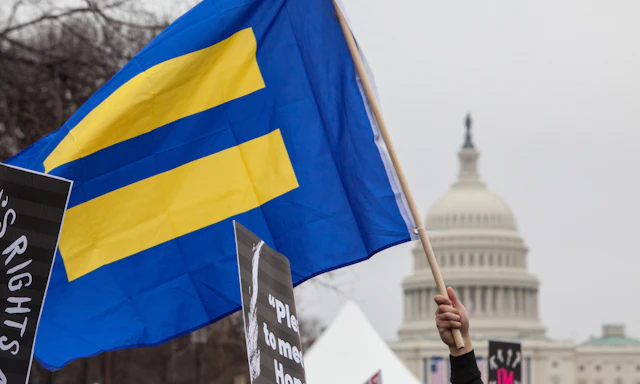 HRC flag with blue background and yellow equal sign flies in front of U.S. Capitol