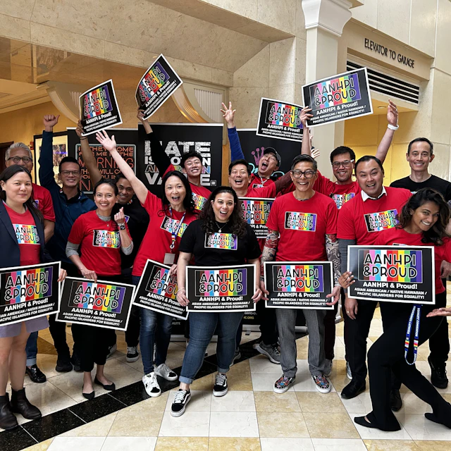 Group photo of the AANHPI committee all holding the progress Pride AANHPI & Proud signs.
